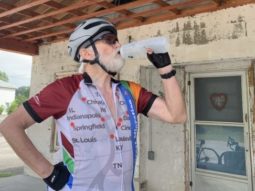 older cyclist drinking water from a bottle