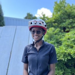 young girl smiling wearing biking clothes